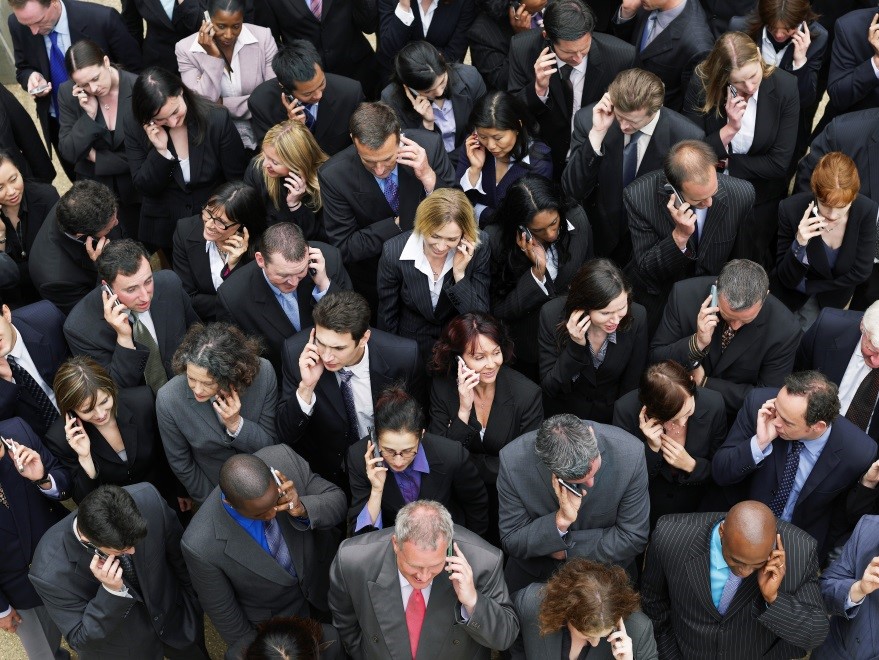 Image of a group of people on their cell phones