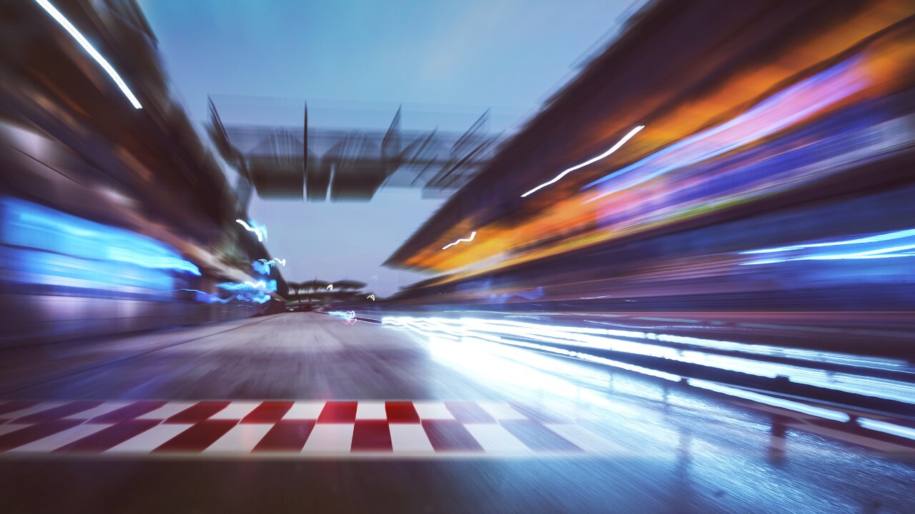 Blurred racetrack with a checkered start line.