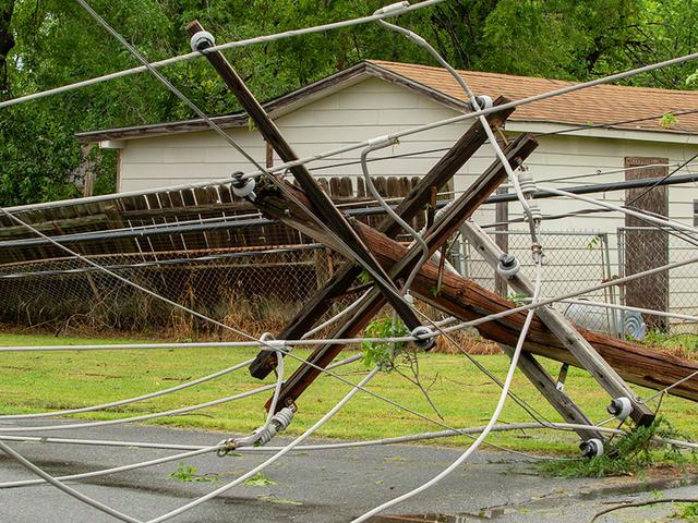 Broken utility pole and downed power lines.