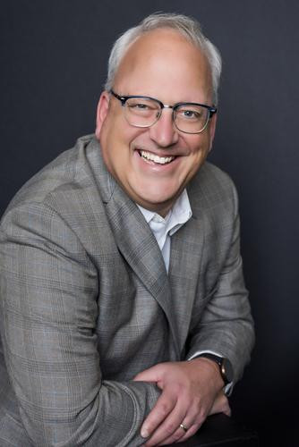 Portrait of a man in a gray blazer