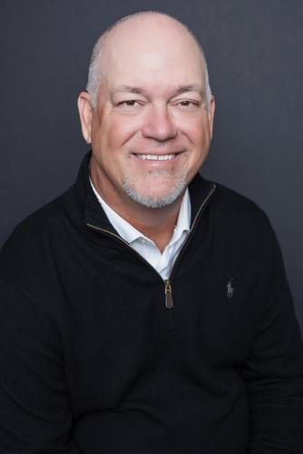 Headshot of a man in a black sweater